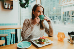 women-enjoying-a-relaxed-meal-alone-at-london-cafe.